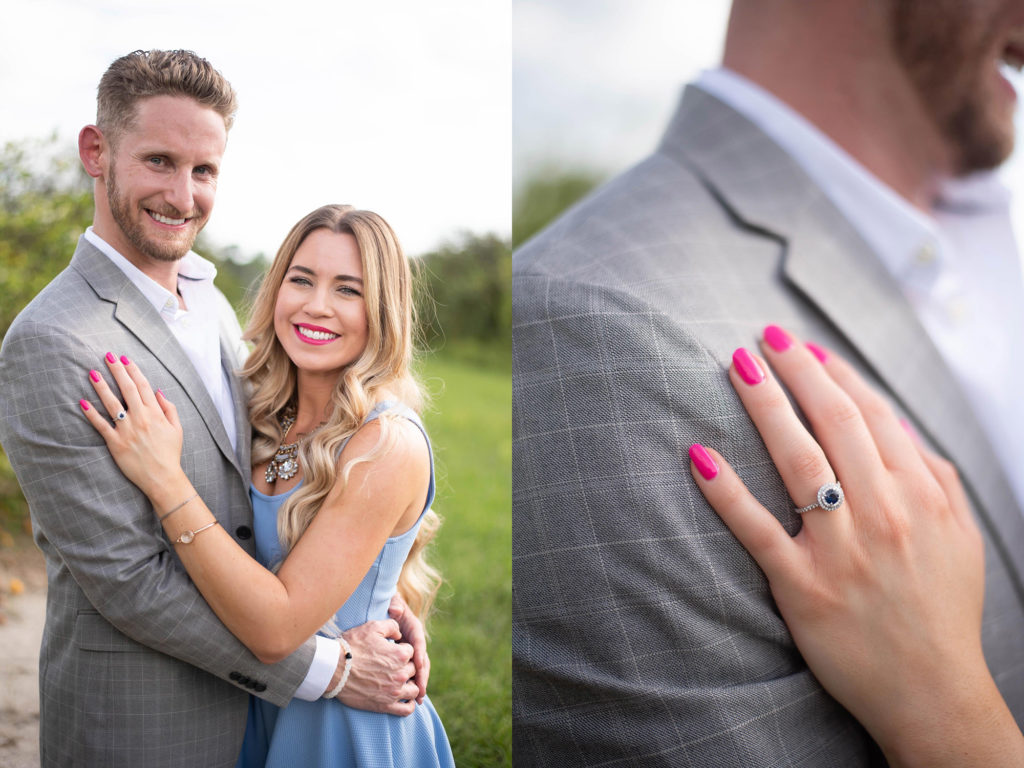 Hancock Orange Groves Engagement Session Couple wearing blue dress and grey blazer smiling wearing blue silver engagement ring