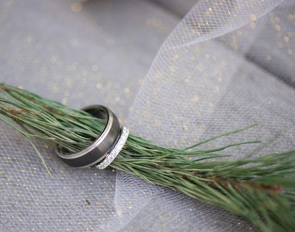 Ybor City Museum Garden Wedding Ring shot with glittery background and a holiday christmas tree garland