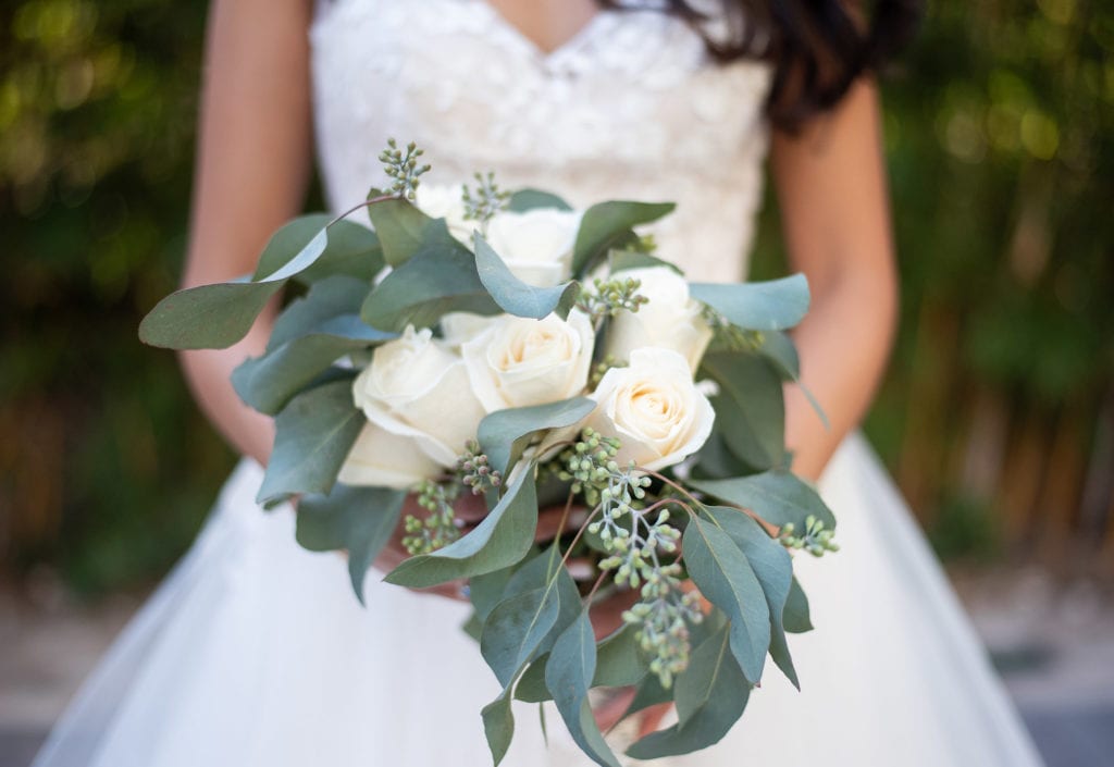 Ybor City Museum Garden Wedding Bride holding White Flowers and Greenery Holiday Bouquet