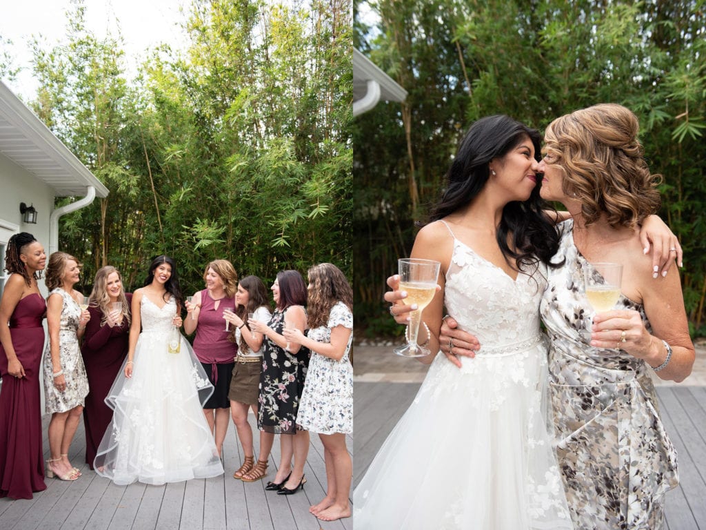 Ybor City Museum Garden Wedding Bride holding champagne bottle and bridesmaids with champagne glasses posing for the camera bride and mom holding champagne eskimo kiss