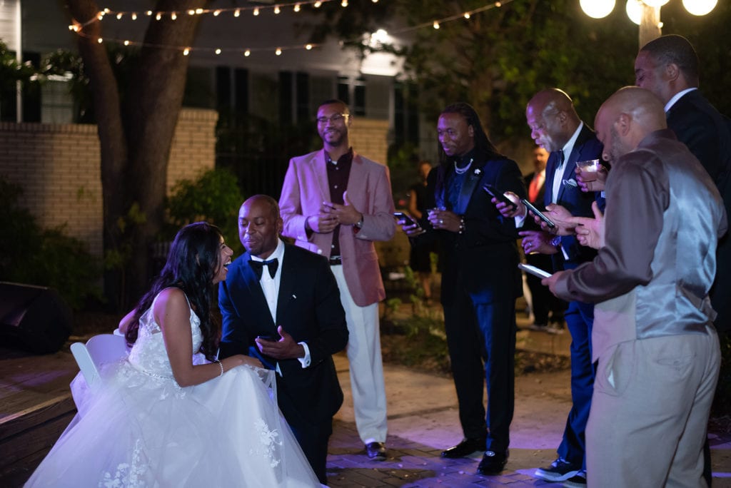 Ybor City Museum Garden wedding groom and groomsmen singing a Capella for bride