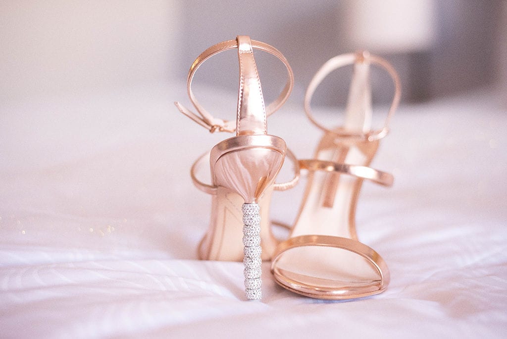 Hyatt Regency Clearwater Beach Wedding Wedding designer shoes in blush color with diamond details on the bed detail shot