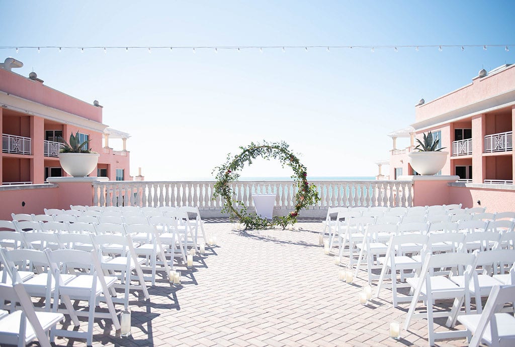 Hyatt Regency Clearwater Beach Wedding Sky terrace with beach blue water pink color walls chairs at ceremony location