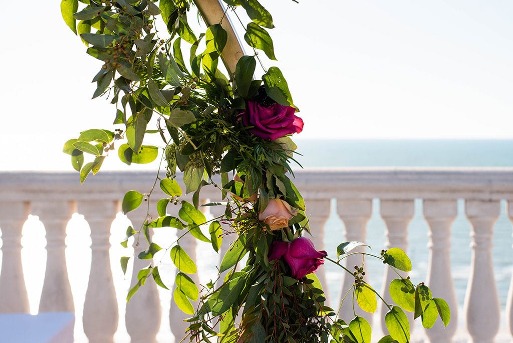 Hyatt Regency Clearwater Beach Wedding floral in pink and garland moon gate arch in the sky terrace by the water 