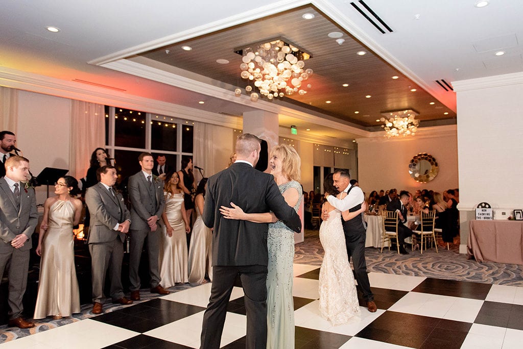Hyatt Regency Clearwater Beach Wedding dual dance bride dancing with father and groom dancing with mother at the same time hollywood themed wedding warm wedding reception lighting decor