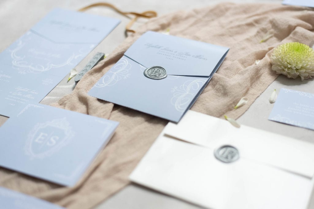 Basic Invite Light Blue Wedding Invitation Suite Flat Lay with silver wax seal luxury look