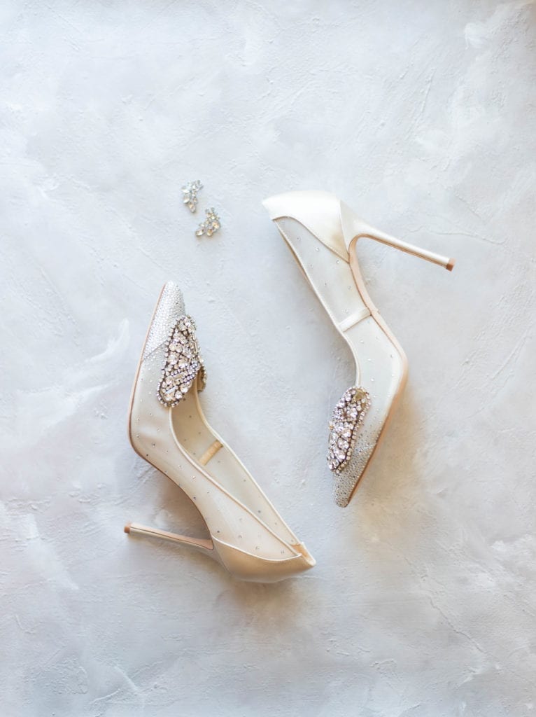 Tampa airport marriott wedding white and silver diamond wedding pumps silver earrings flat lay photography
