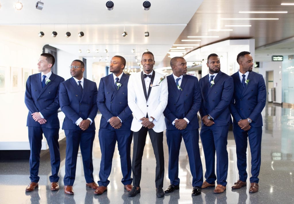 Groom and groomsmen posing at Tampa international airport