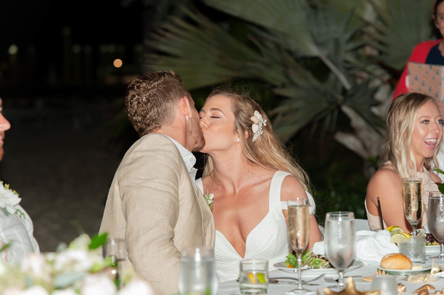 bride and groom kissing during wedding reception in florida