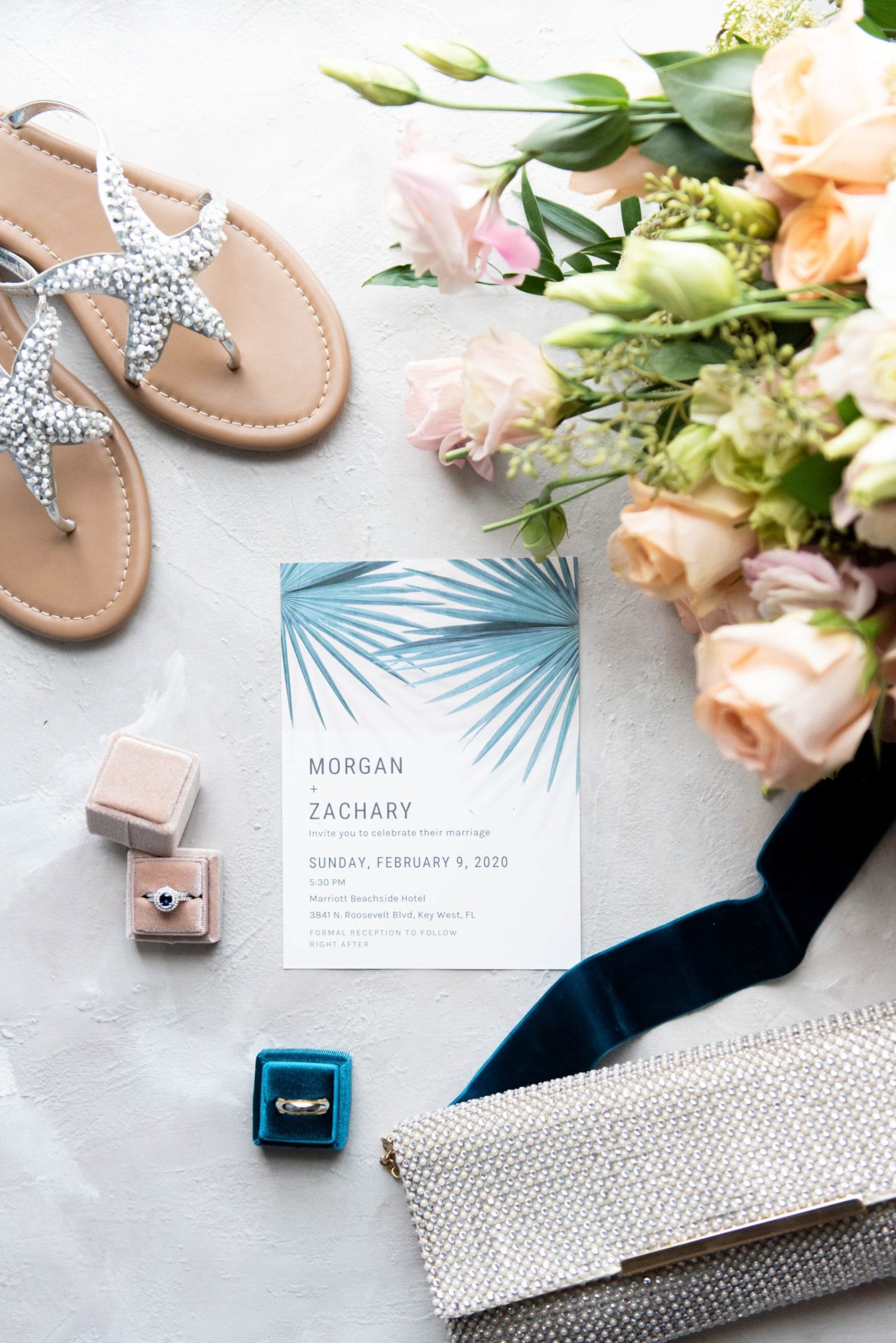 blush and teal wedding flatlay invitations wedding rings in mrs box flower bouquet and bride's shoes and purse