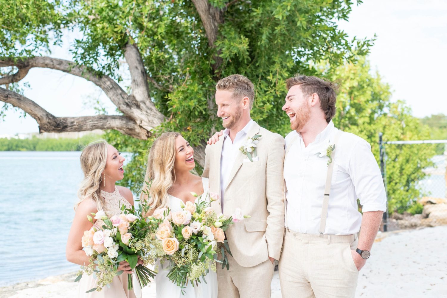 Key west wedding in Florida at Marriott beachside hotel during Spring bridal party photo with bride, groom, bridesmaid and groomsmen