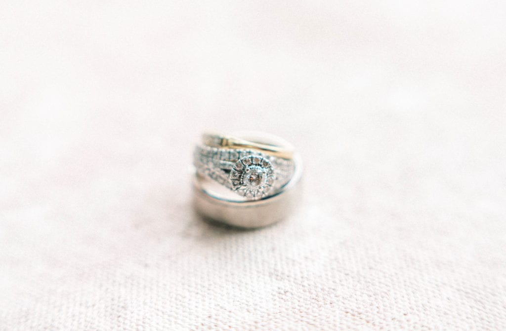 Diamond engagement ring and wedding ring bands photo on a pink background wedding details