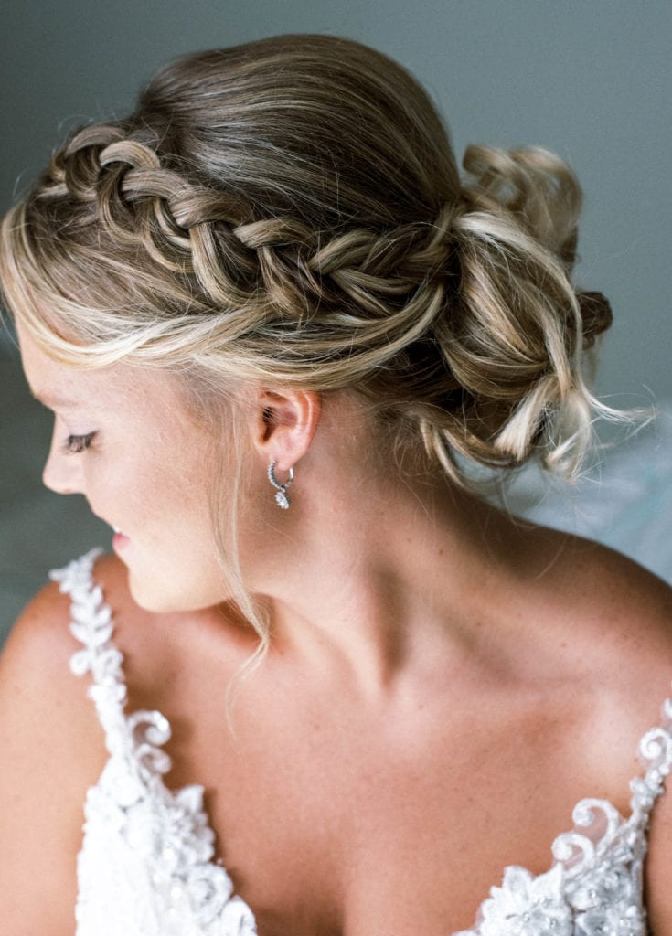 Tampa bride getting ready photo hair in a bun with a side braid natural looking make up wedding dress details