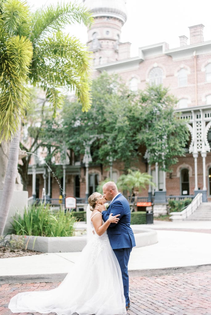 University of Tampa wedding photos bride and groom kissing in front of UT