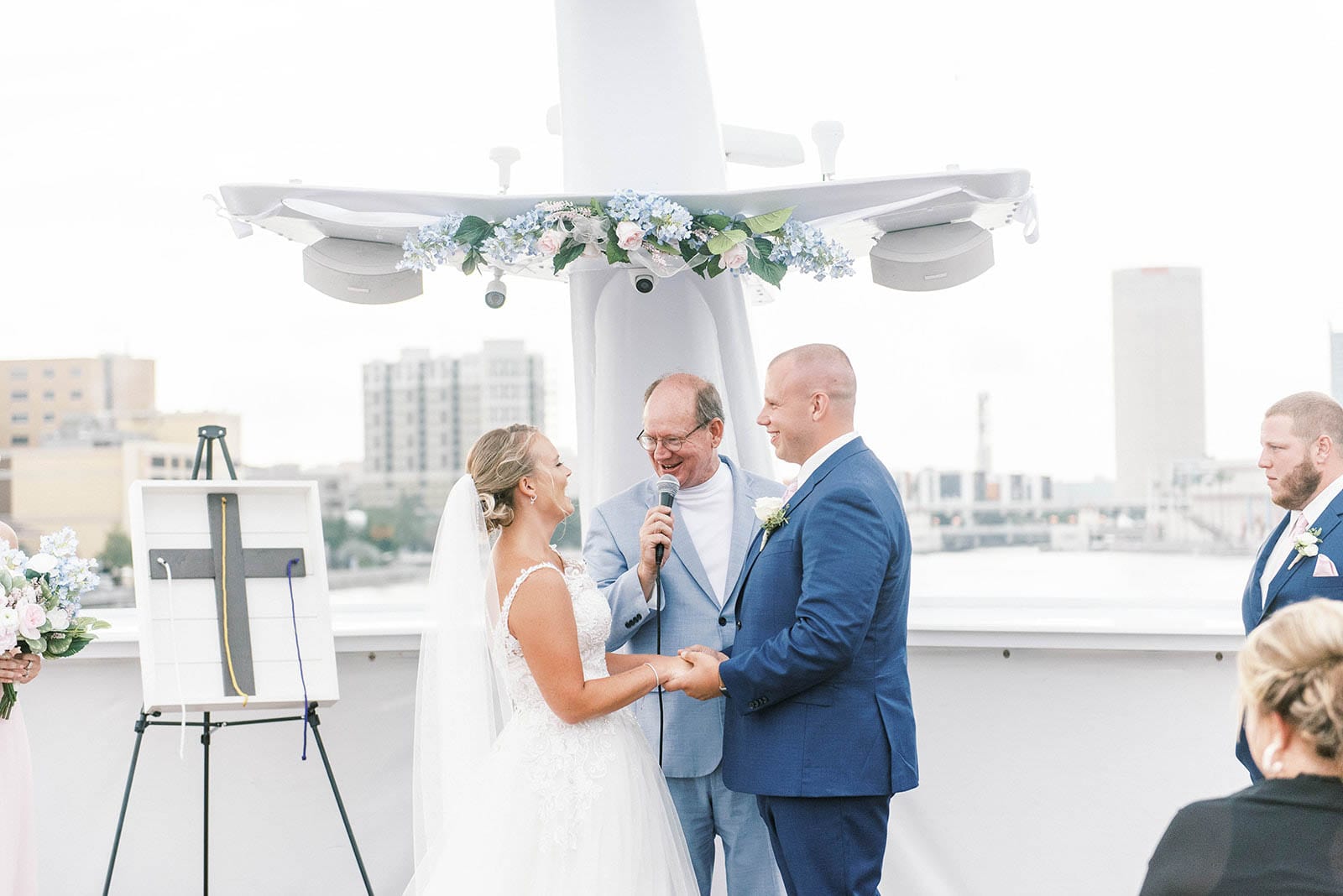 Yacht Starship Wedding Tampa Micro Wedding Yacht Wedding Ceremony overlooking Downtown Tampa couple holding hands, wedding officiant marrying them