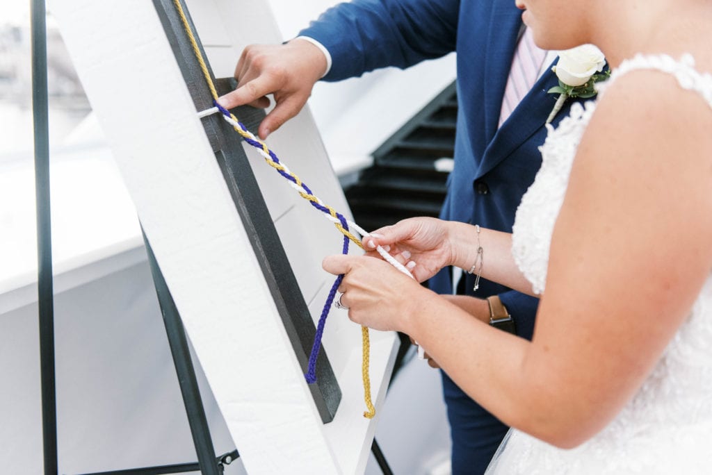 Yacht Starship Tampa wedding bride and groom tying cord of three strands during ceremony