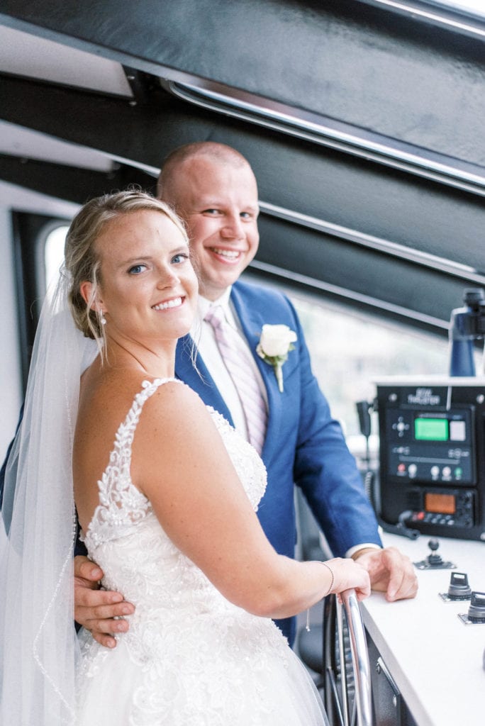 Bride and groom at yacht starship tampa control room driving yacht