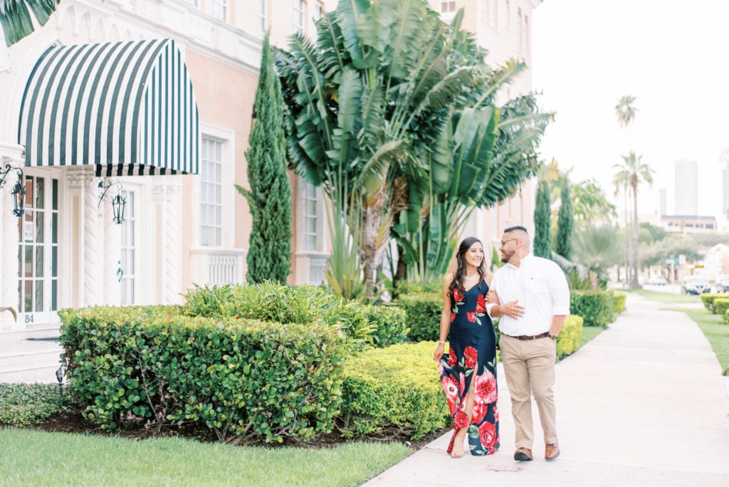 The mirasol photos Davis island engagement session couple walking by the mirasol holding hands