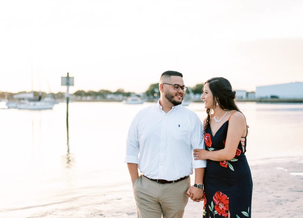 Davis Island Engagement Photos Beach photos in Tampa Florida Yacht Couple holding hands looking at each at the beach during sunset