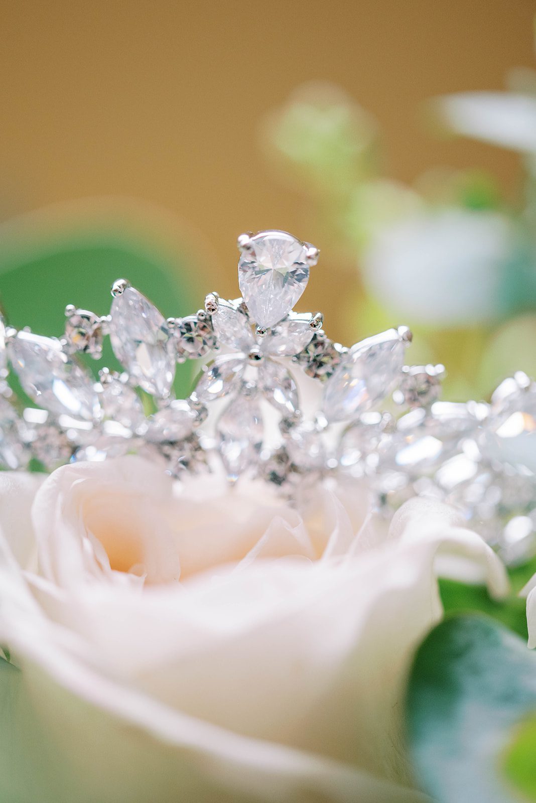 diamond tiara on top of some wedding day roses