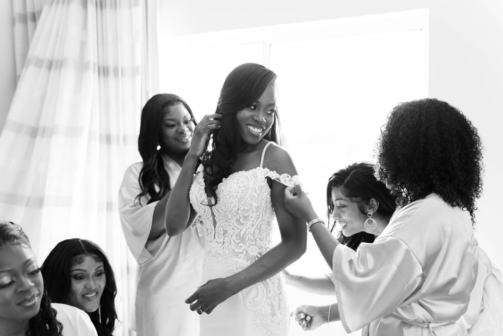 black and white photo of a Florida bride getting ready with her brides maids before her wedding ceremony