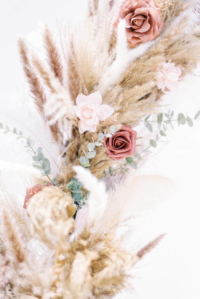 wedding florals of pompous grass, blush flowers and eucalyptus leaves