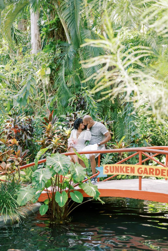 Sunken Gardens Engagement Session Best engagement session locations in Tampa and Central Florida couple embracing each other on the red bridge