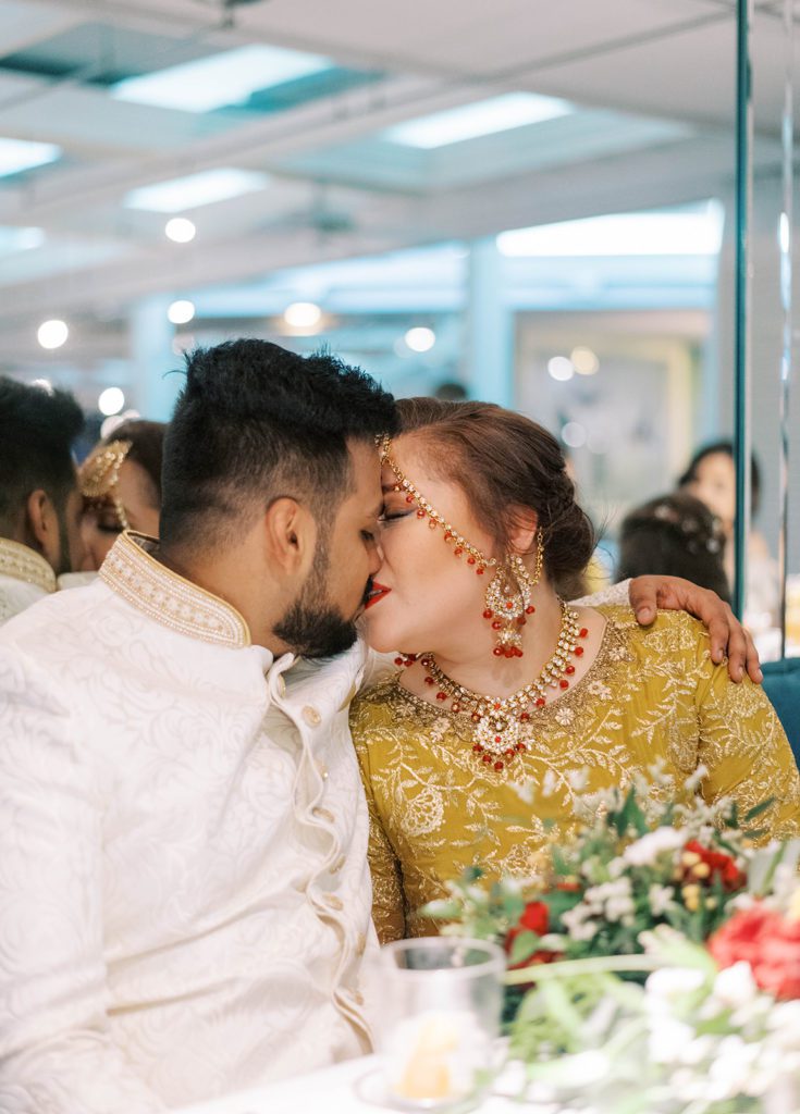 Florida indian wedding photographer bride and groom kissing during wedding reception