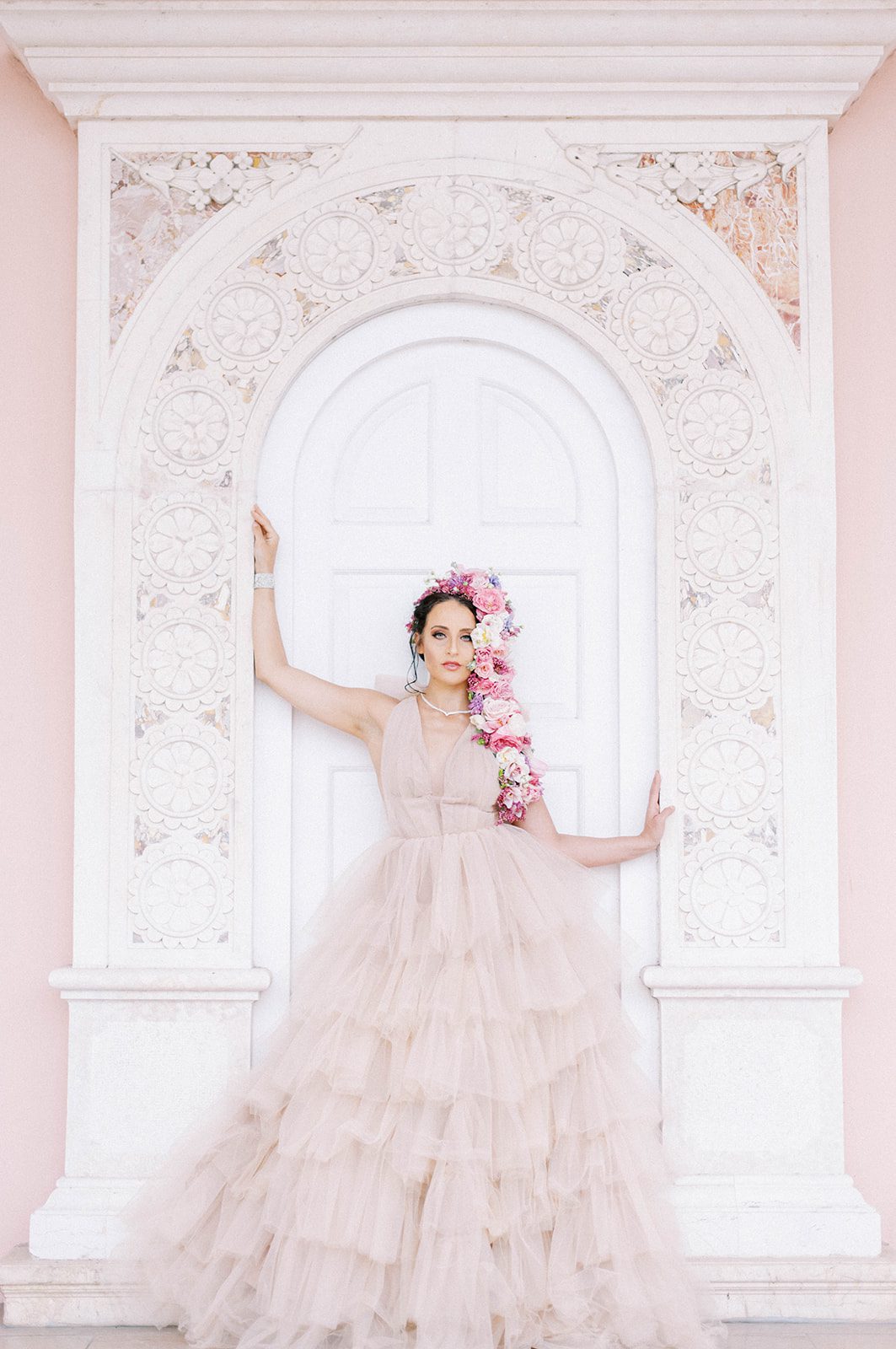 luxury bridal dress in light pink ruffles and bride wearing florals in her hair for a Tampa Florida wedding