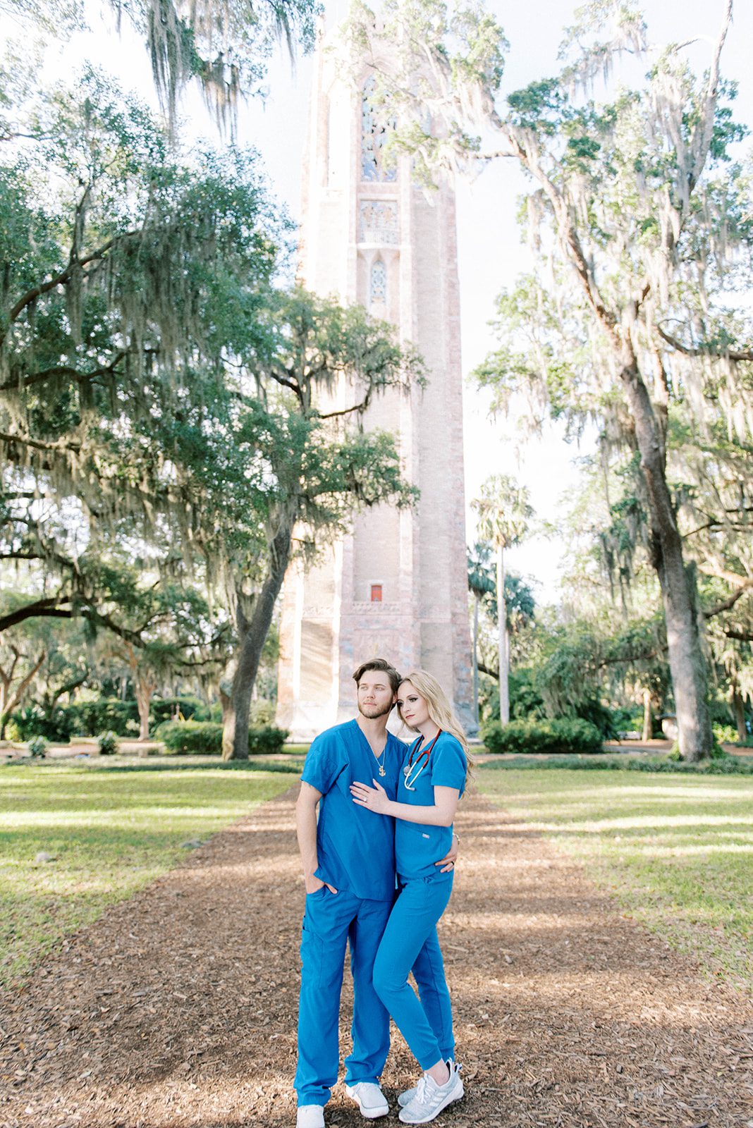 Bok Tower Garden engagement session in Tampa Florida with engaged couple in scrubs posing in front of the tower