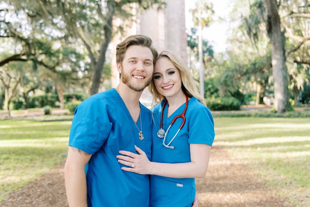 Tampa engagement session with man and womanis blue scrub because they are nurses smiling with each other 