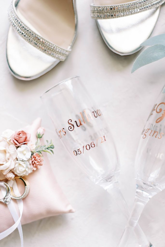 Wedding rings custom wedding champagne and silver bridal shoes flatlay tampa wedding photography