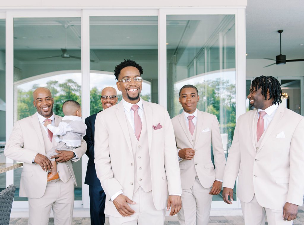 Groom and groomsmen professional photo walking and smiling at camera for tampa wedding