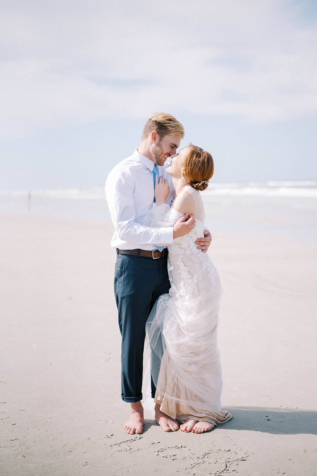 minimalist beach wedding in Florida with bride and groom embracing each other on the New Smyrna Beach