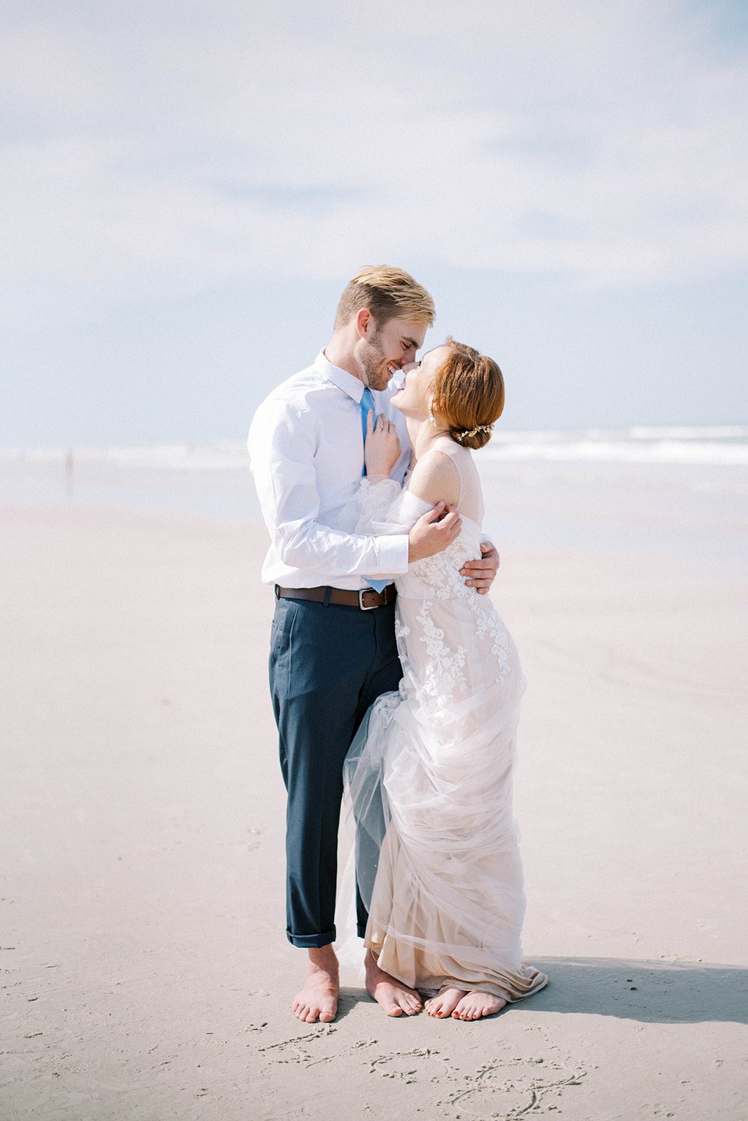 minimalist beach wedding in Florida with bride and groom embracing each other on the New Smyrna Beach