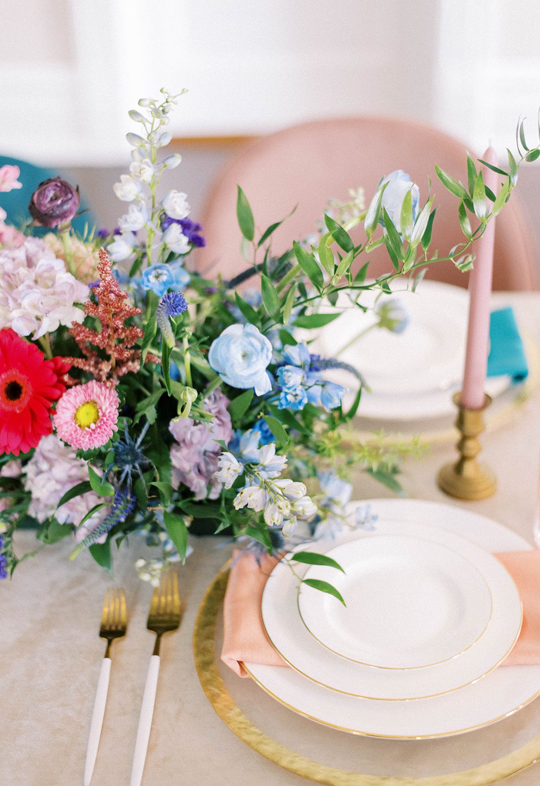 wedding inspiration at the Orlo with a simple and brightly colored table setting for a reception space with bright flowers as the centerpiece