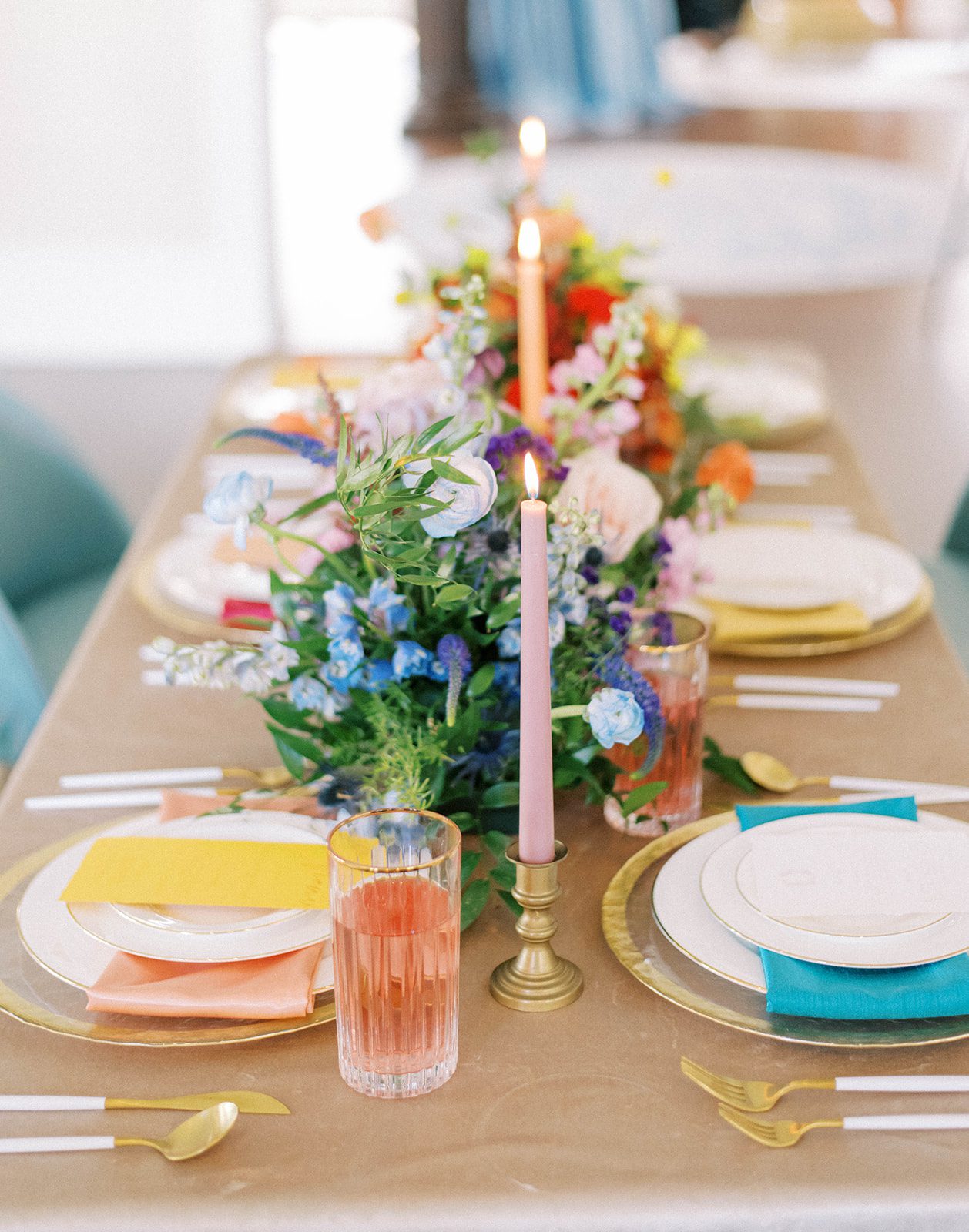 bright and vibrant wedding day table setting at The Orlo for a retro wedding inspiration with bright florals and tall candles