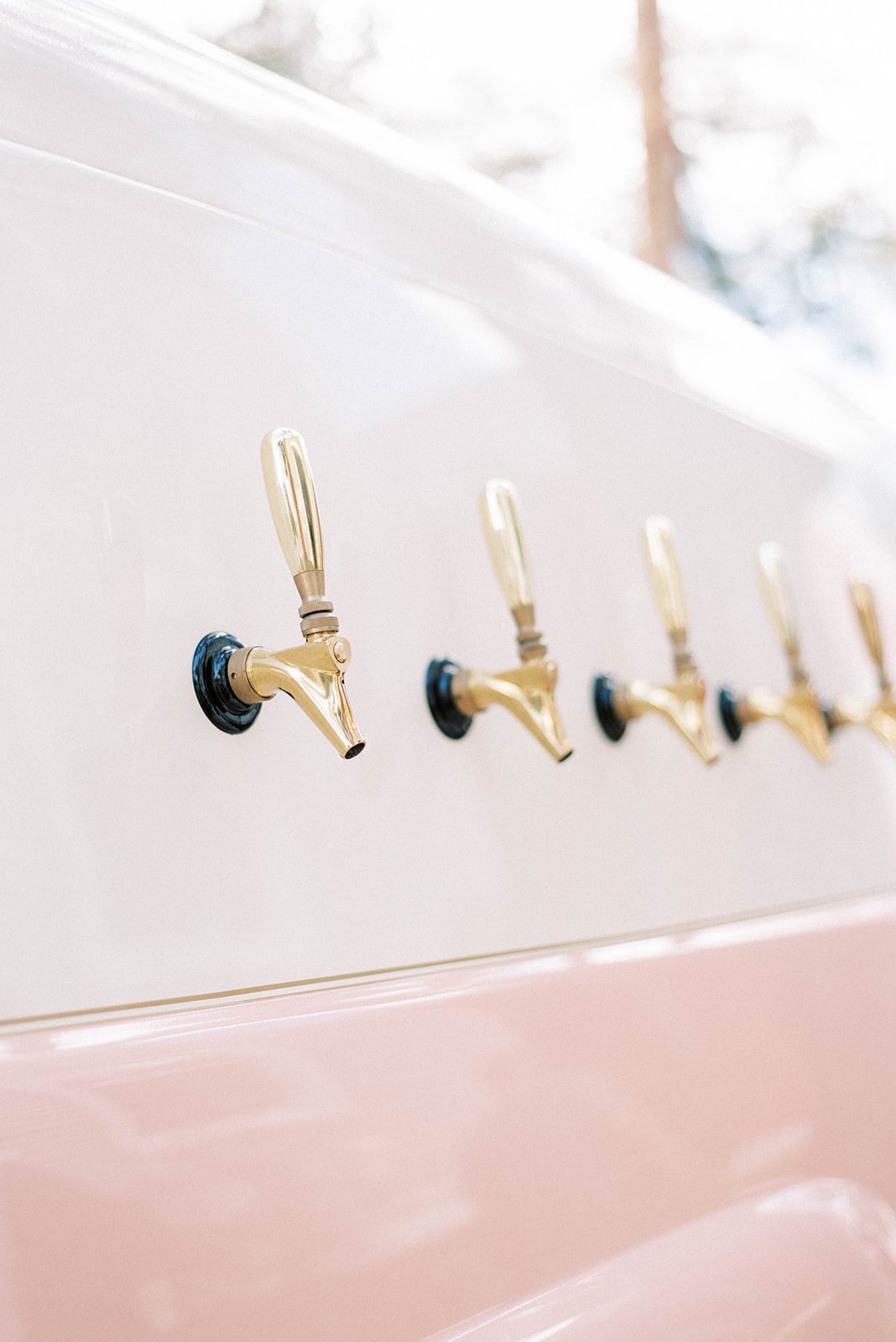 pink and white taptruck with gold taps