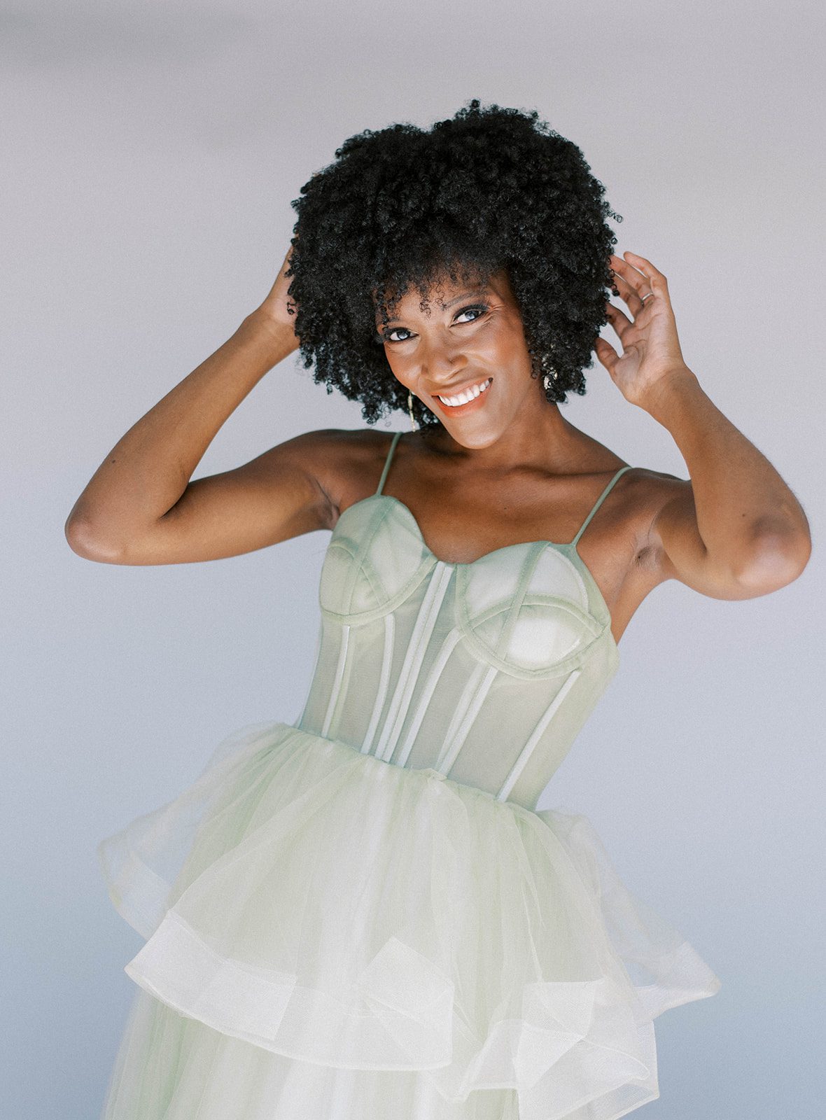 colorful bridal fashion wedding dress in green with structured boning in the bodice of the gown with Tampa Florida model posing and smiling