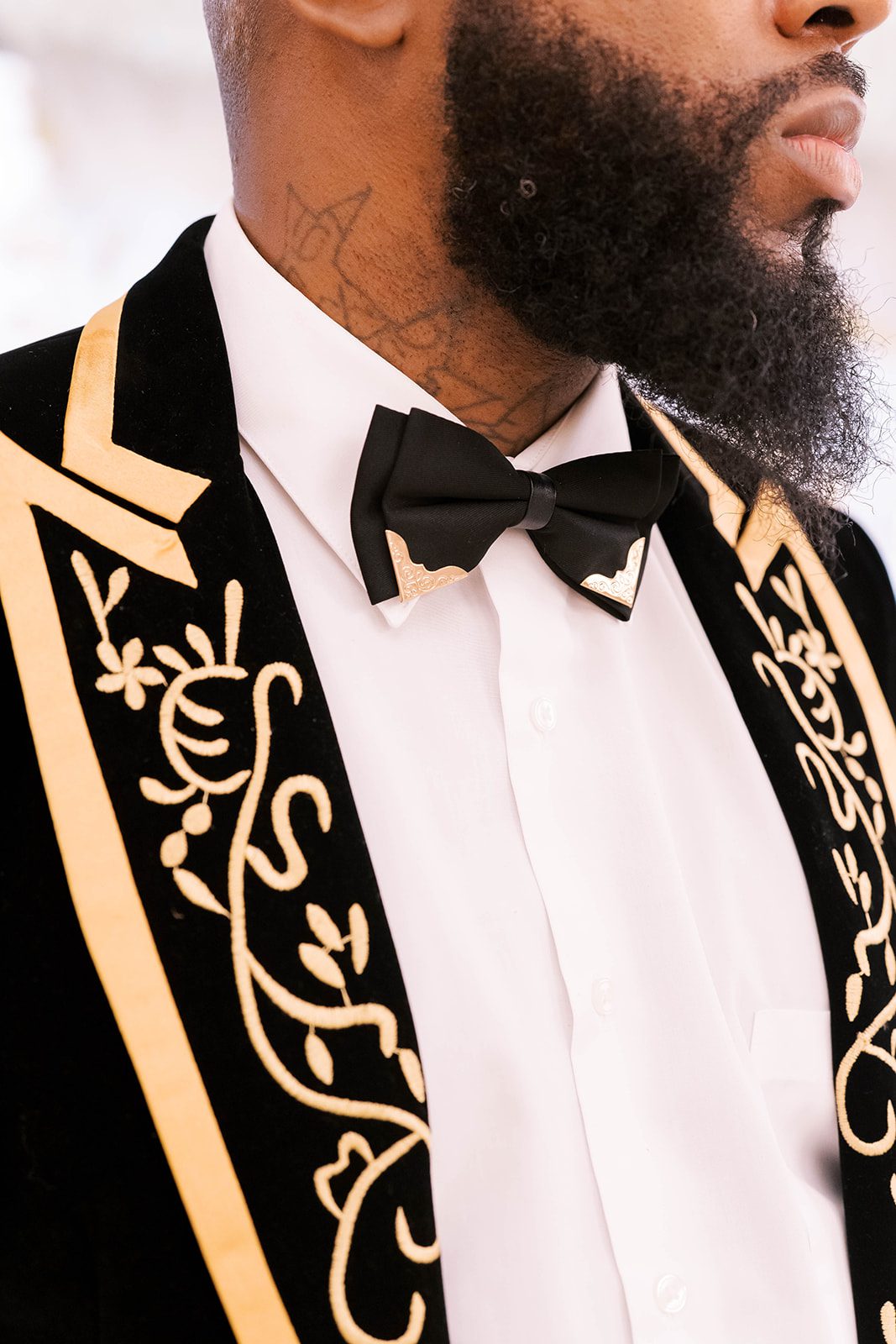 close up shot of grooms black suit with gold detailing and bow tie for a high end Tampa FLorida wedding day with Tampa's best wedding photographers