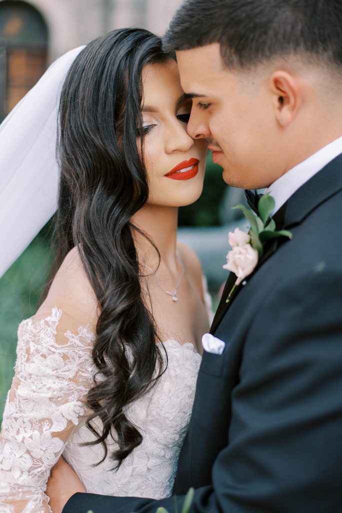 bride and groom embracing one another on their Tampa Bay wedding day with the grooms nose gently touching the brides cheek as she closes her eyes, wedding planner