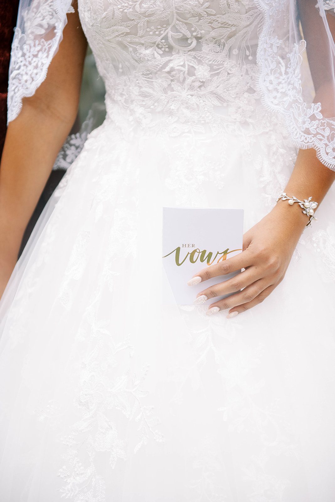 bride holding onto her private vows card to read to her groom during their first look at Tampa wedding venue