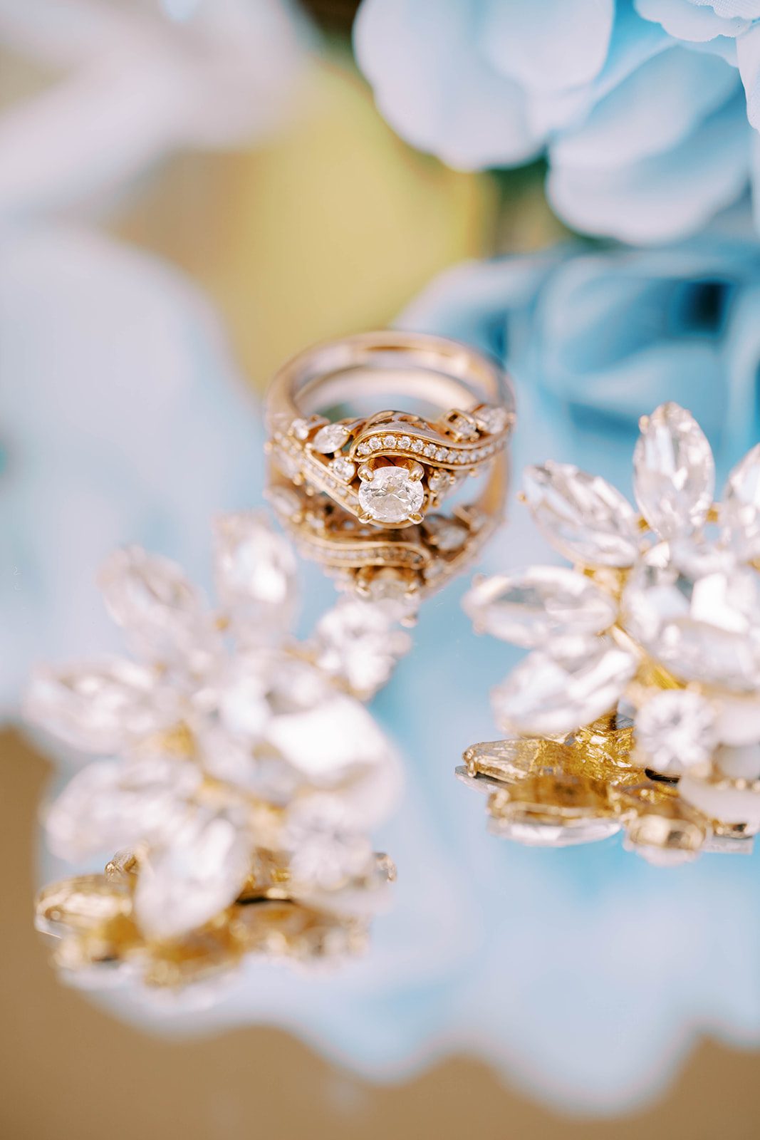 detail shots of brides earrings and rings at the Chic Venue Golden Palace