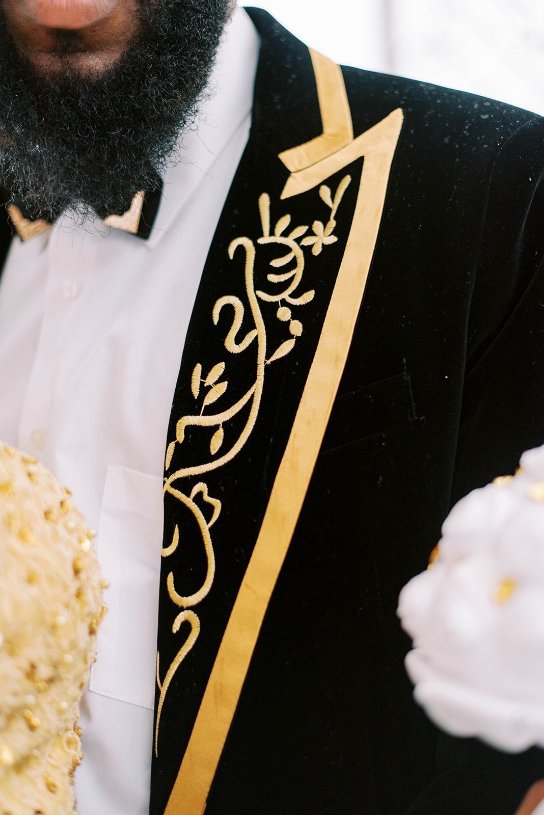grooms black suit coat with gold embroidery for a luxury wedding in Tampa Bay captured by best Tampa wedding photographer