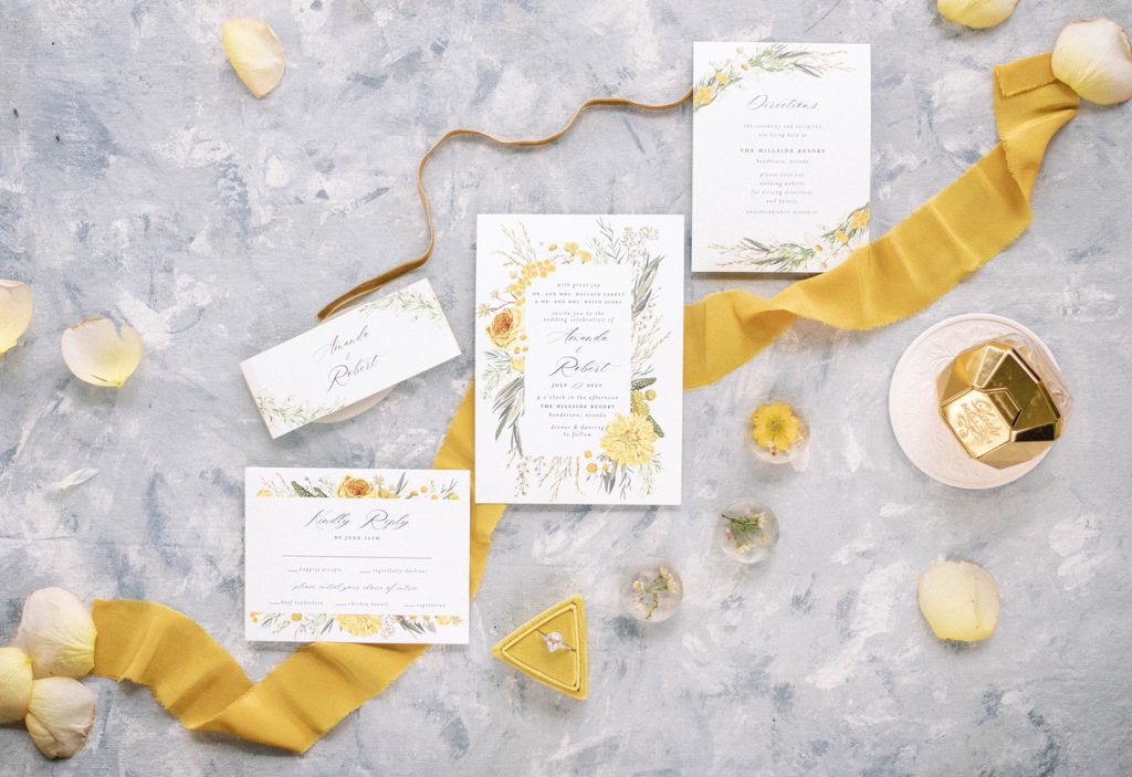 pretty yellow wedding flatlay with picture perfect wedding invitations and other yellow details