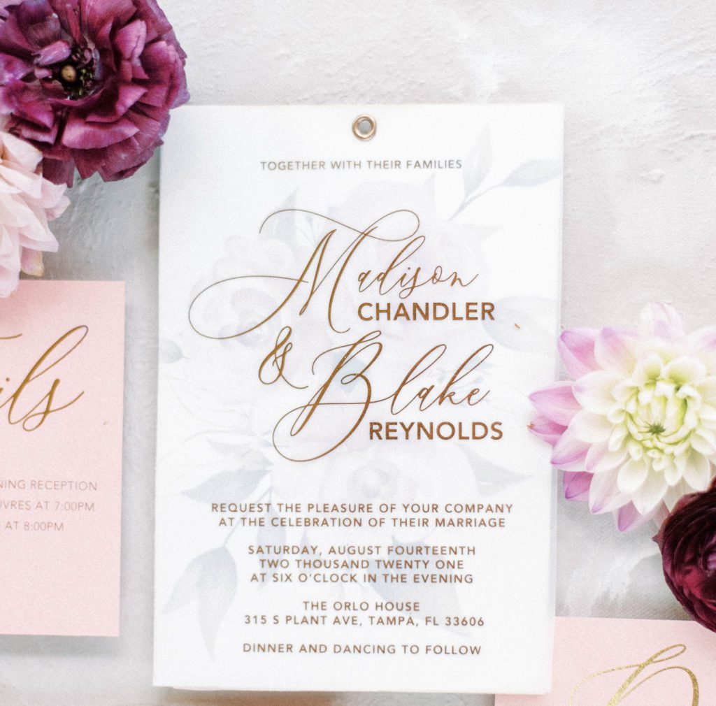 elegant wedding invitations with dark moody purple florals surrounding the invite for a wedding flatlay image
