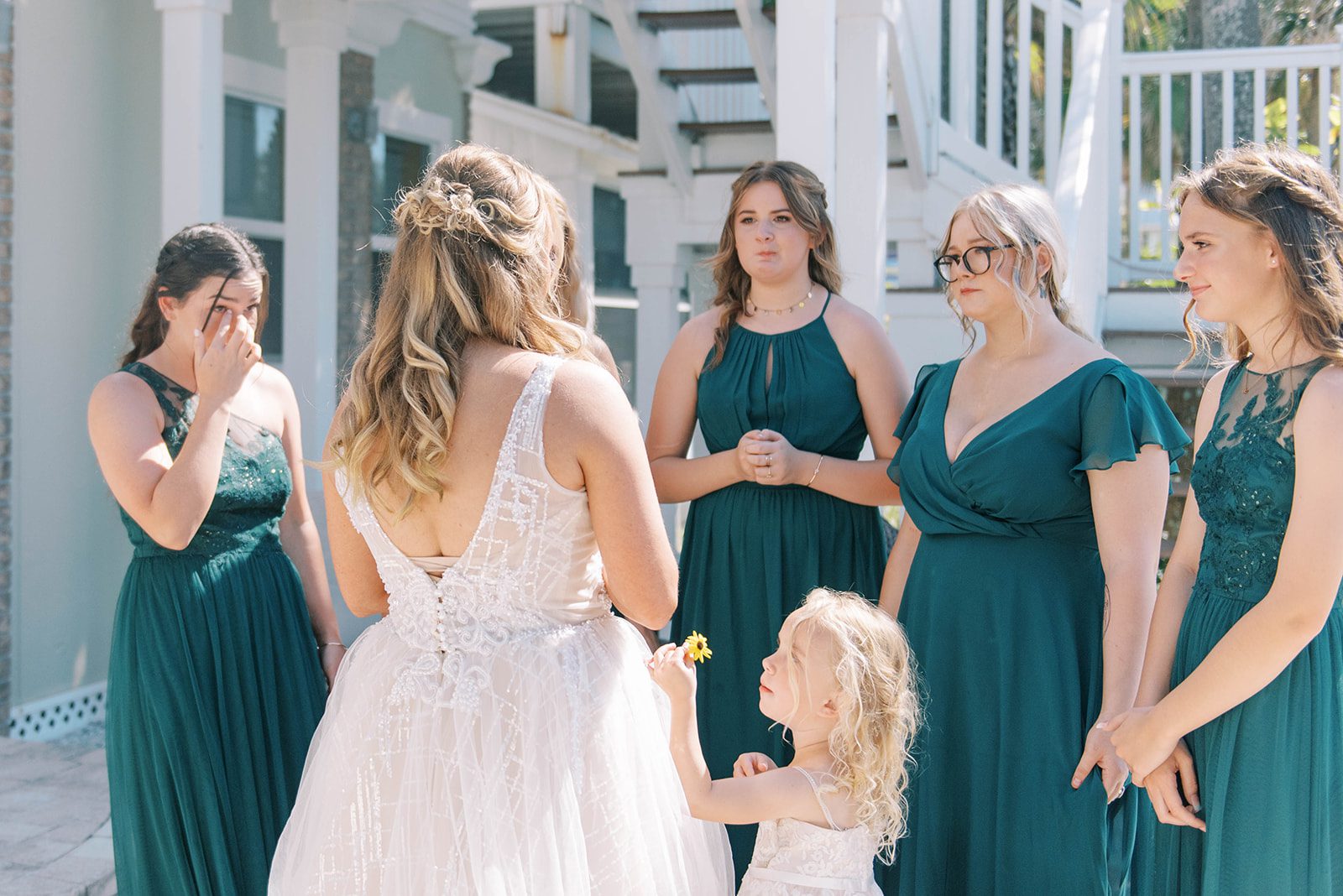 daughter reacting to their mothers dress during a first look on her Florida beach wedding