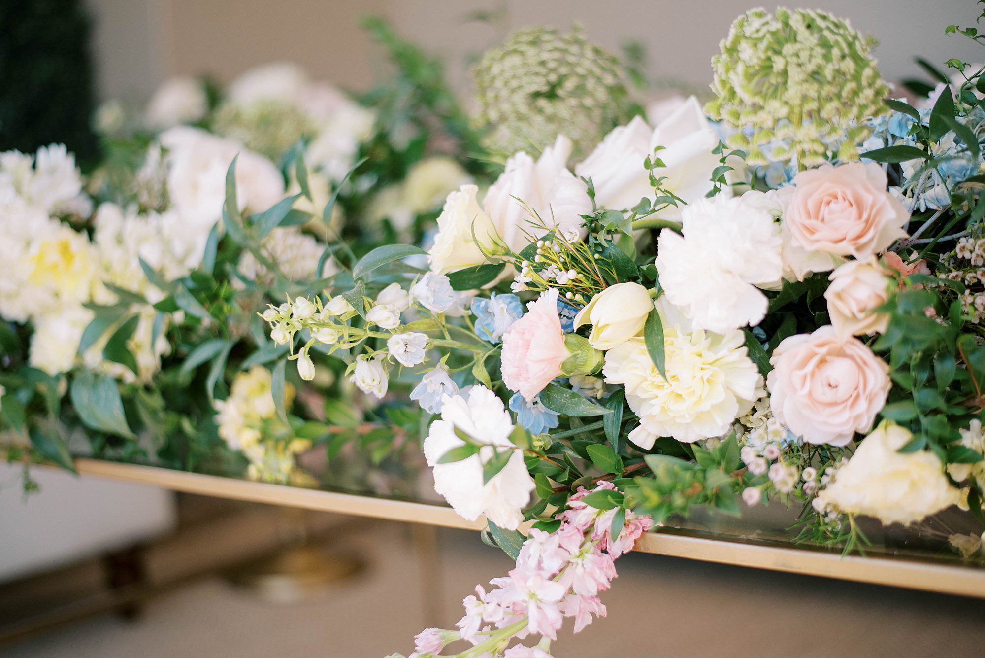 floral arrangement sits on gold table at Hotel Zamora wedding