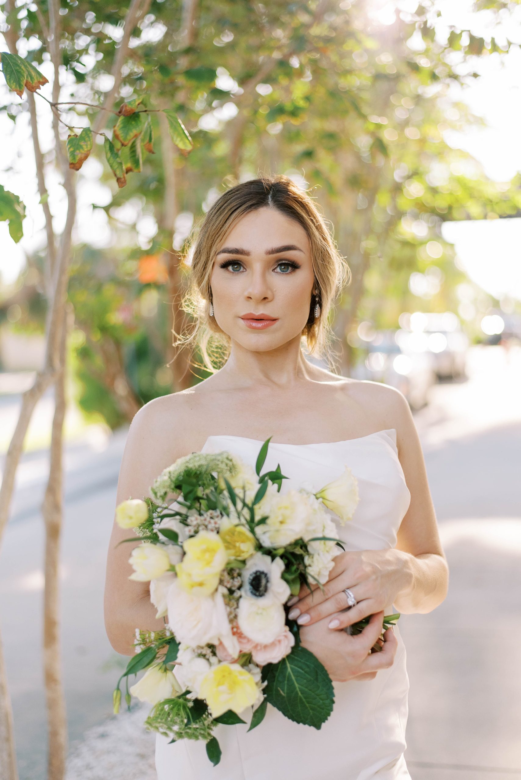 bride holds bouquet of white flowers during FL wedding
