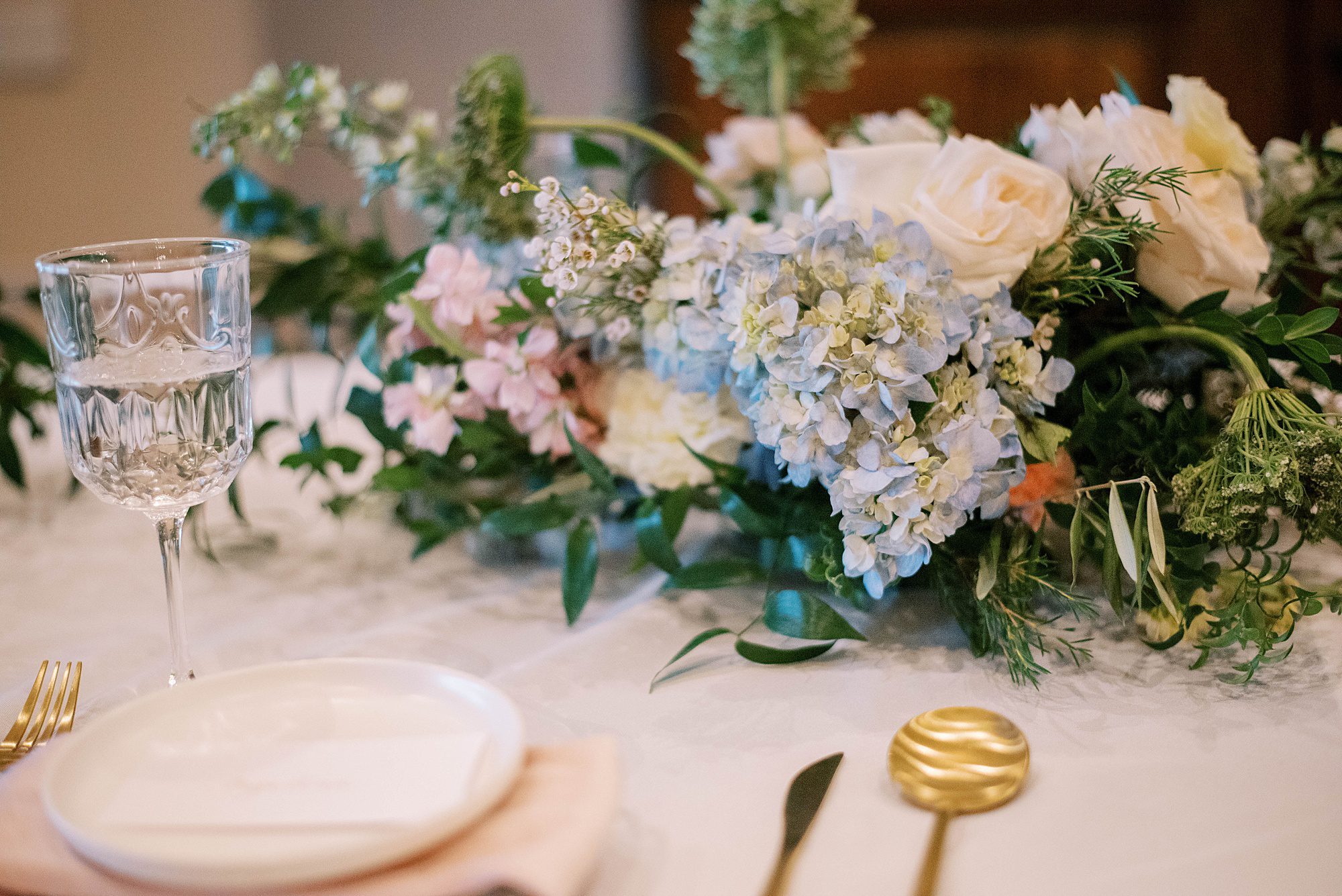 wedding reception with pink and blue floral centerpieces